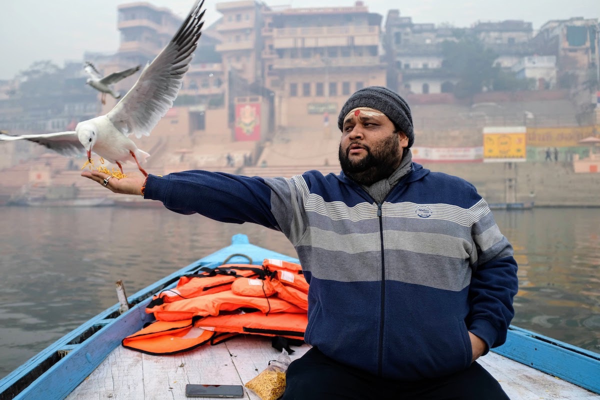 Utkarsh feeding birds on boat